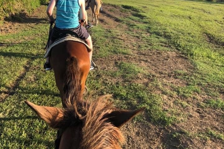 a person riding a bike down a dirt road